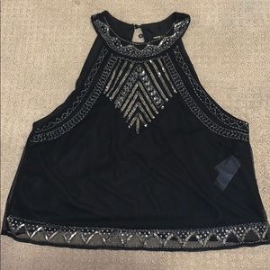 Sleeveless dress shirt with beading detail